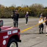 Former UK soldier units off for 100 km charity stroll, pulling a Land Rover